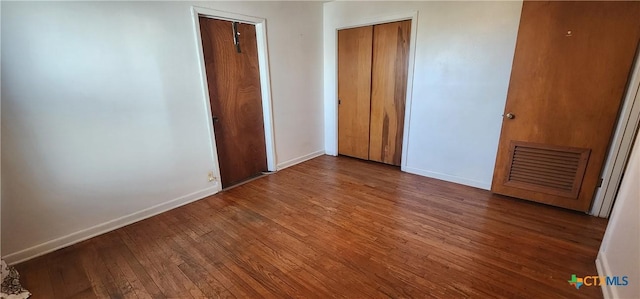 3605 Oaklawn St, Victoria, TX 77901 - unfurnished bedroom featuring hardwood / wood-style floors and baseboards