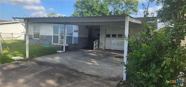3605 Oaklawn St, Victoria, TX 77901 - view of front facade with asphalt driveway, a front lawn, an attached carport, and a garage