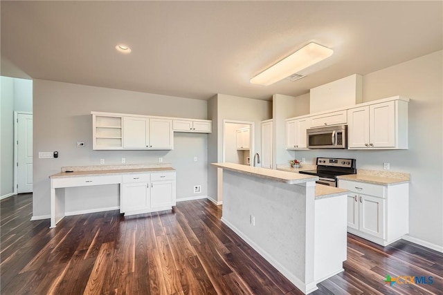 kitchen featuring sink, white cabinets, dark hardwood / wood-style flooring, a center island, and stainless steel appliances