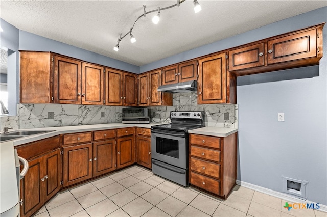 4210 Sand Dollar Dr, Killeen, TX 76549 - kitchen with electric range, under cabinet range hood, brown cabinets, decorative backsplash, and a textured ceiling
