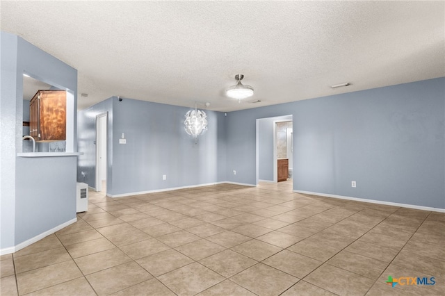 4210 Sand Dollar Dr, Killeen, TX 76549 - spare room featuring a textured ceiling and light tile patterned flooring