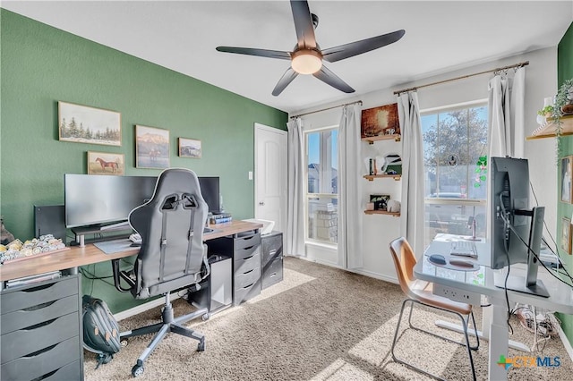 carpeted home office with ceiling fan