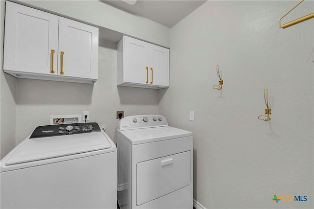 laundry room featuring cabinets and washer and dryer