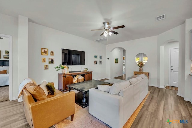 living room with ceiling fan and light hardwood / wood-style floors