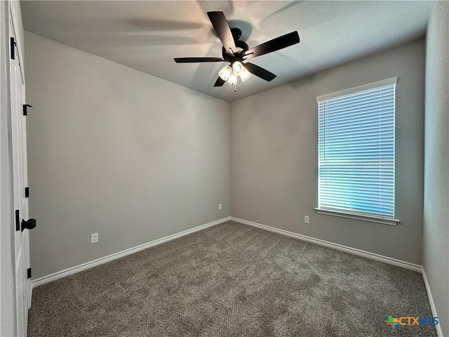 carpeted spare room with a wealth of natural light and ceiling fan