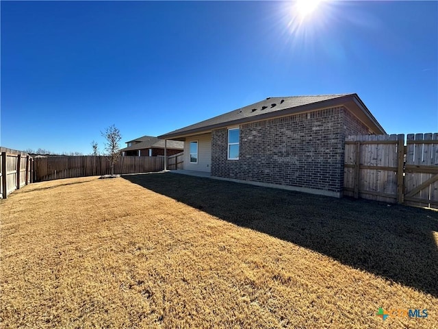 rear view of house with a yard