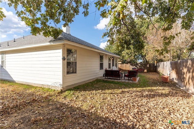 view of side of home featuring a patio area