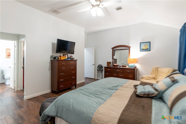 bedroom with ensuite bath, dark wood-type flooring, and ceiling fan