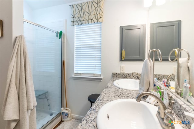 bathroom featuring vanity and a shower with door