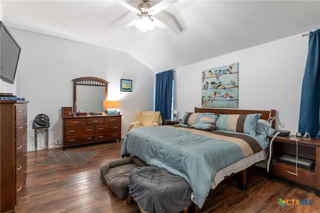 bedroom featuring dark hardwood / wood-style flooring, ceiling fan, and vaulted ceiling