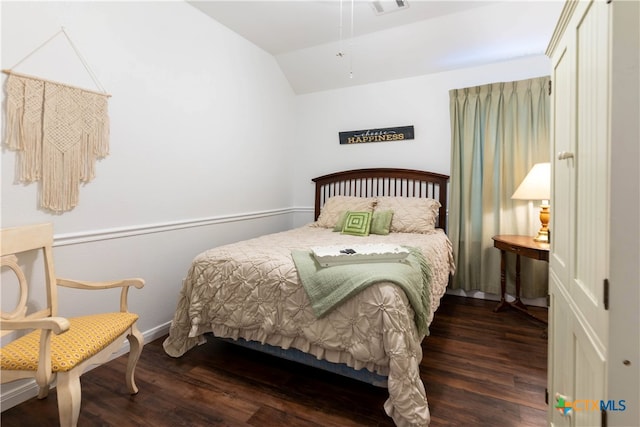 bedroom featuring dark wood-type flooring and vaulted ceiling