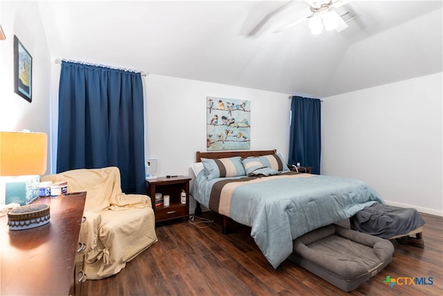 bedroom featuring dark hardwood / wood-style flooring, vaulted ceiling, and ceiling fan