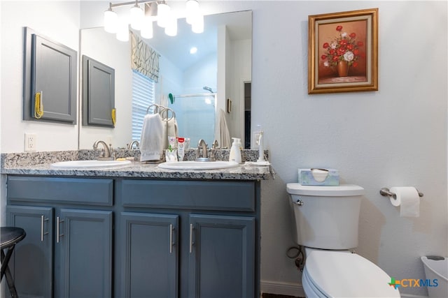 bathroom with a shower with door, vanity, toilet, and vaulted ceiling