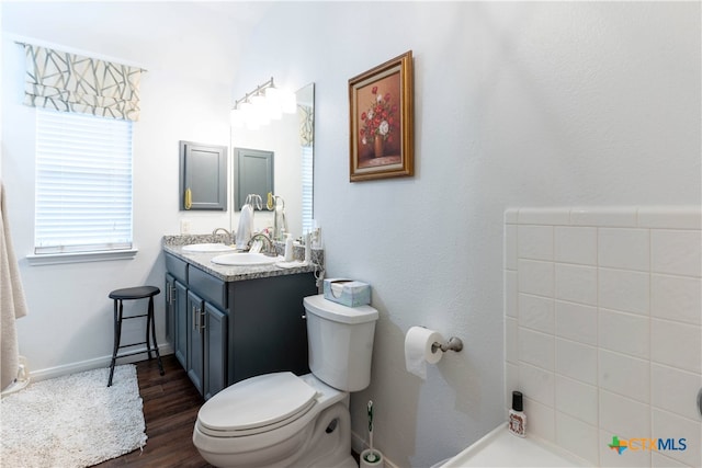 bathroom with toilet, vanity, and hardwood / wood-style floors