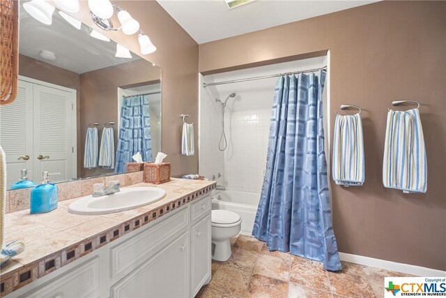 350 Climbing Way, Wimberley, TX 78676 - full bathroom with baseboards, vanity, shower / bath combo, toilet, and stone finish floors