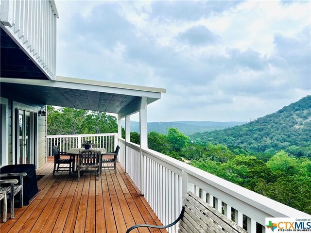 350 Climbing Way, Wimberley, TX 78676 - wooden deck with outdoor dining space and a view of trees