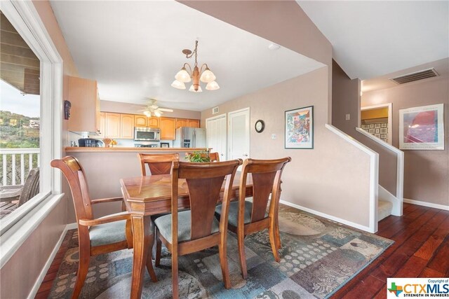 350 Climbing Way, Wimberley, TX 78676 - dining room with baseboards, a chandelier, dark wood-style floors, and stairs