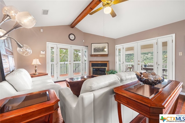 living room featuring plenty of natural light, vaulted ceiling with beams, and french doors