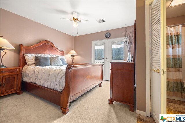 carpeted bedroom featuring french doors, ceiling fan, and access to exterior