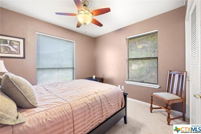 350 Climbing Way, Wimberley, TX 78676 - bedroom with light carpet, baseboards, and ceiling fan