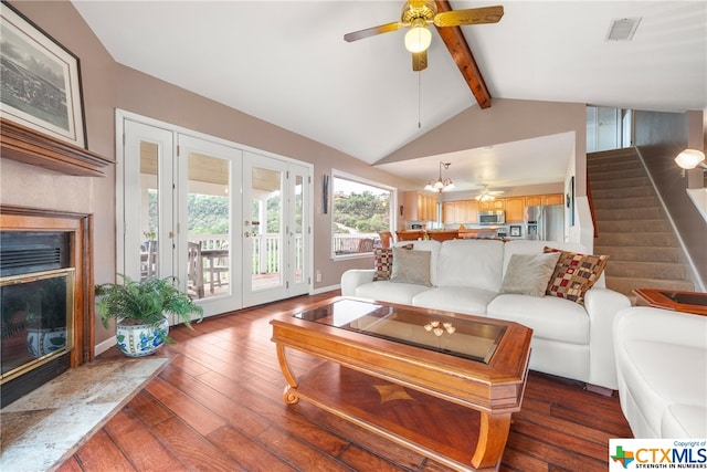 living room with french doors, lofted ceiling with beams, dark hardwood / wood-style flooring, and ceiling fan with notable chandelier