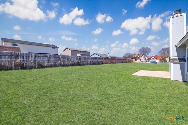 view of yard with a residential view and fence