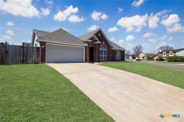 view of front of property with driveway, brick siding, a front yard, and fence