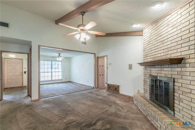 unfurnished living room featuring a brick fireplace, carpet flooring, vaulted ceiling with beams, and visible vents