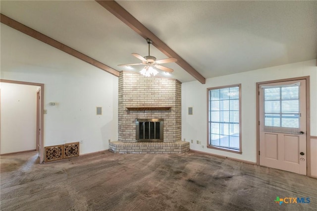 unfurnished living room featuring lofted ceiling with beams, a fireplace, carpet flooring, and a ceiling fan