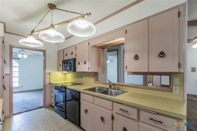 kitchen featuring ornamental molding, light floors, light countertops, black appliances, and a sink