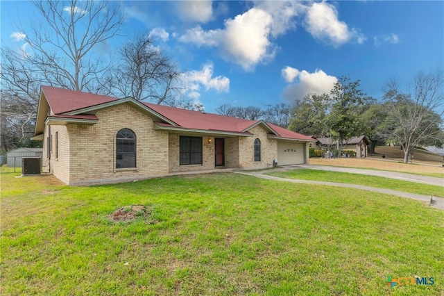 single story home with an attached garage, driveway, a front lawn, and brick siding