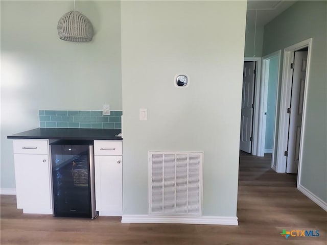 1211 W Houson Ave, Seadrift, TX 77983 - bar featuring visible vents, wine cooler, baseboards, and wood finished floors