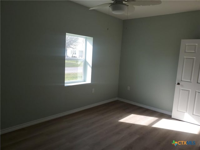 1211 W Houson Ave, Seadrift, TX 77983 - spare room featuring baseboards, dark wood-type flooring, and ceiling fan