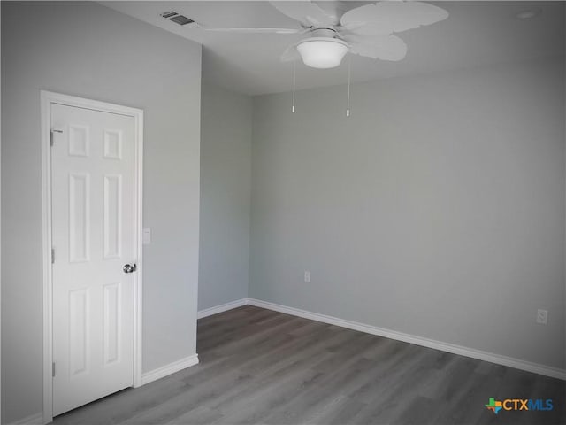 1211 W Houson Ave, Seadrift, TX 77983 - spare room with a ceiling fan, baseboards, visible vents, attic access, and dark wood-type flooring