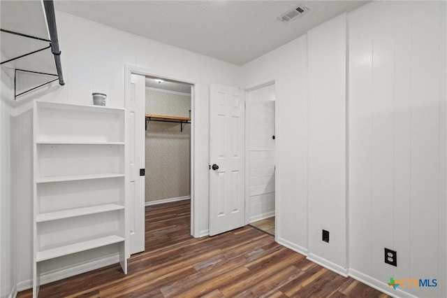 4101 Briar Cliff Rd, Temple, TX 76502 - unfurnished bedroom featuring dark wood-style floors, a closet, and a walk in closet