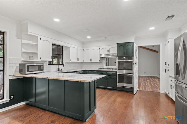 4101 Briar Cliff Rd, Temple, TX 76502 - kitchen with stainless steel appliances, a peninsula, white cabinetry, a textured ceiling, and open shelves