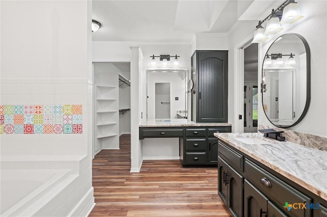 4101 Briar Cliff Rd, Temple, TX 76502 - bathroom featuring wood finished floors, vanity, a bath, and ornamental molding