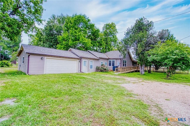 view of front of house featuring a garage, a wooden deck, and a front lawn