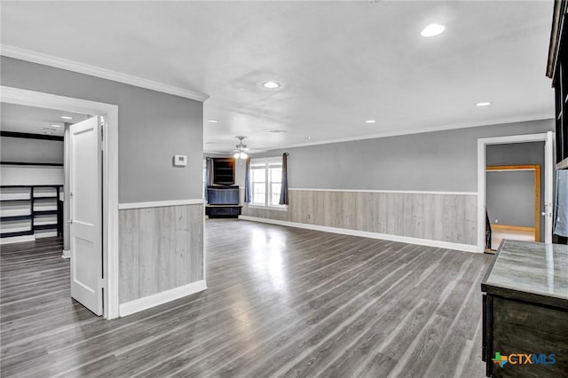 unfurnished living room with hardwood / wood-style floors, ceiling fan, and crown molding