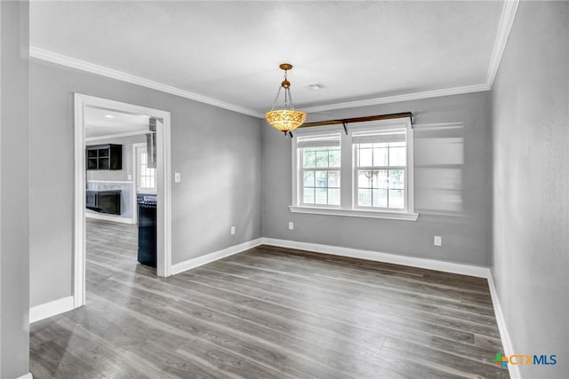 unfurnished room featuring wood-type flooring and ornamental molding