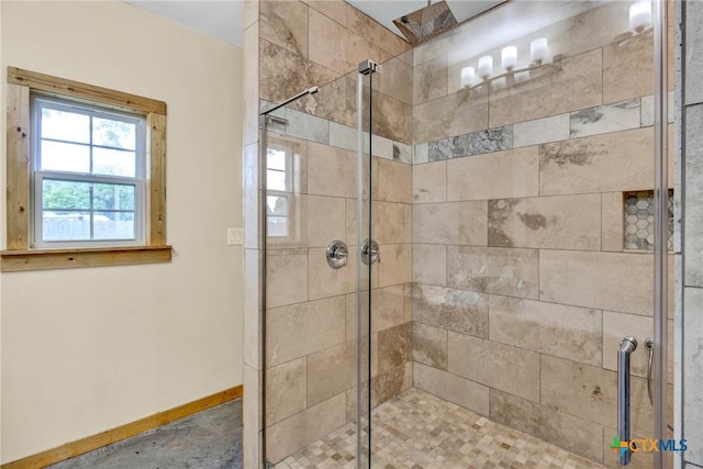 bathroom with a shower with door