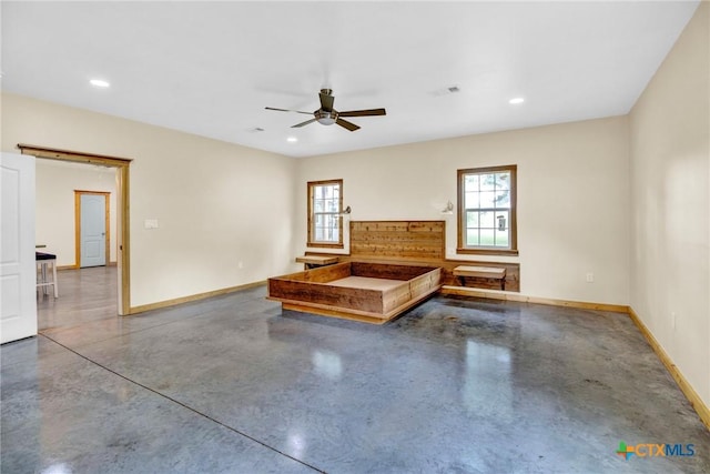 interior space with ceiling fan and concrete flooring