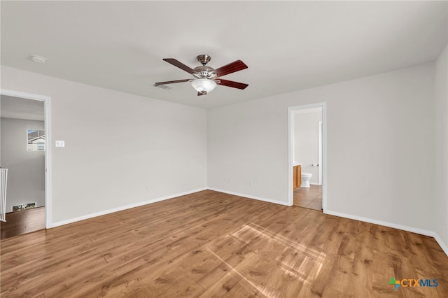 spare room with light hardwood / wood-style flooring, ceiling fan, and radiator