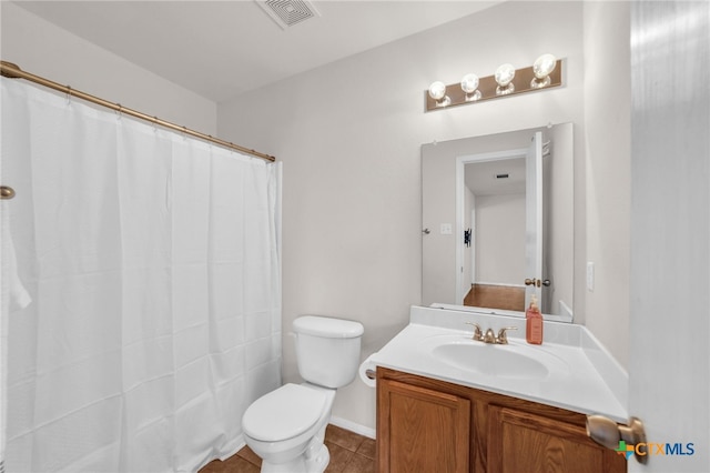 bathroom featuring toilet, vanity, and tile patterned floors