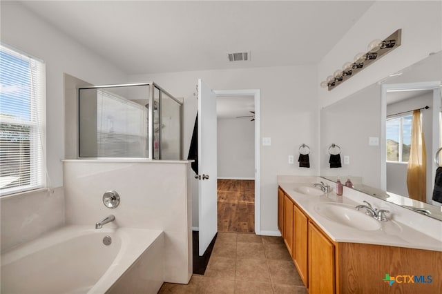 bathroom with independent shower and bath, vanity, tile patterned flooring, and plenty of natural light