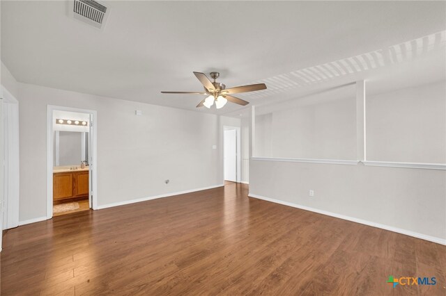 empty room with dark wood-type flooring and ceiling fan