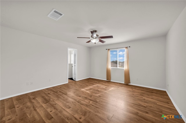 spare room with hardwood / wood-style flooring and ceiling fan