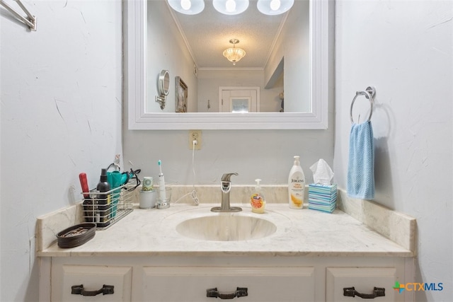 bathroom featuring vanity, a textured ceiling, and crown molding