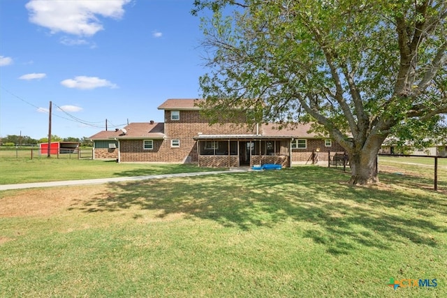 rear view of house with a lawn