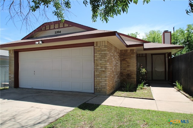 ranch-style home featuring a garage